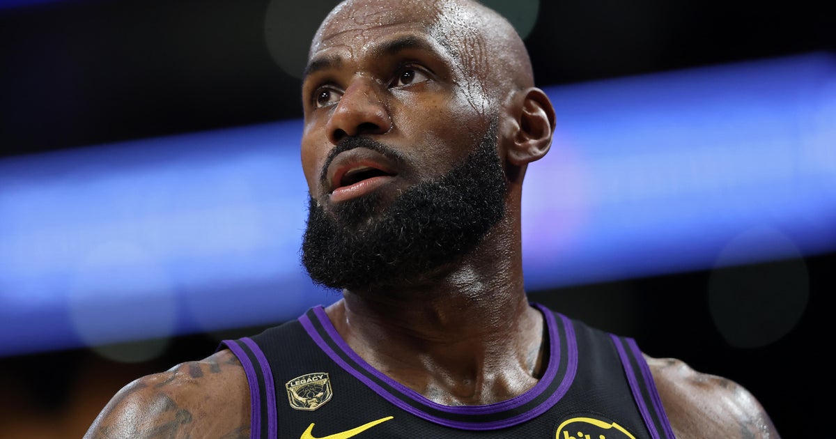 LeBron James in a Los Angeles Lakers uniform walking off the court after a game