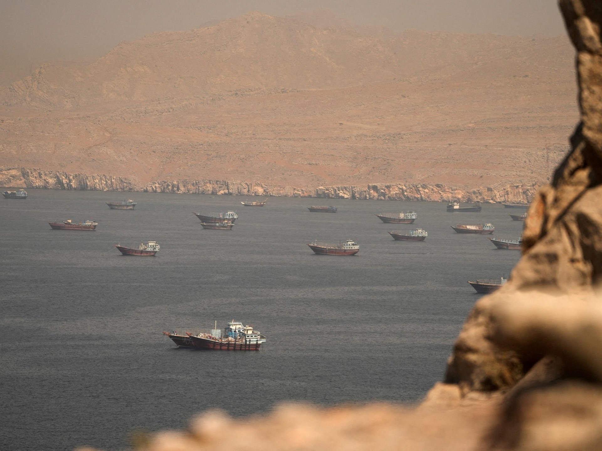 Oil tankers sailing through the Strait of Hormuz as crude prices fall back toward pre-war levels