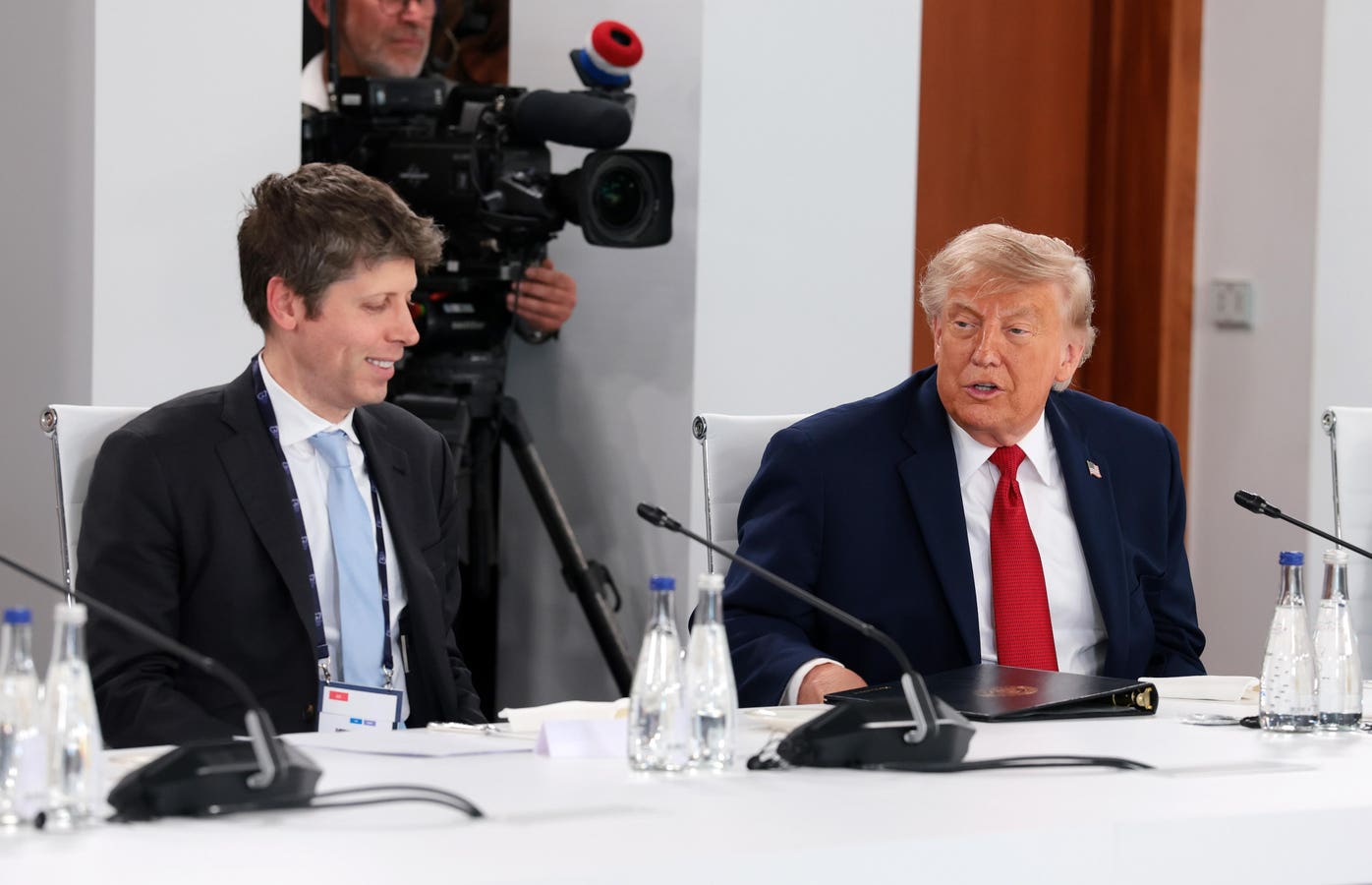 OpenAI CEO Sam Altman speaking at a podium as officials discuss a government equity stake in leading US artificial intelligence companies